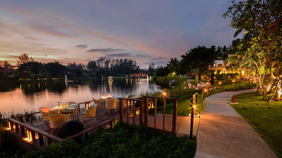 The Watercourt restaurant deck on the lagoon at sunset, Banyan Tree Phuket
