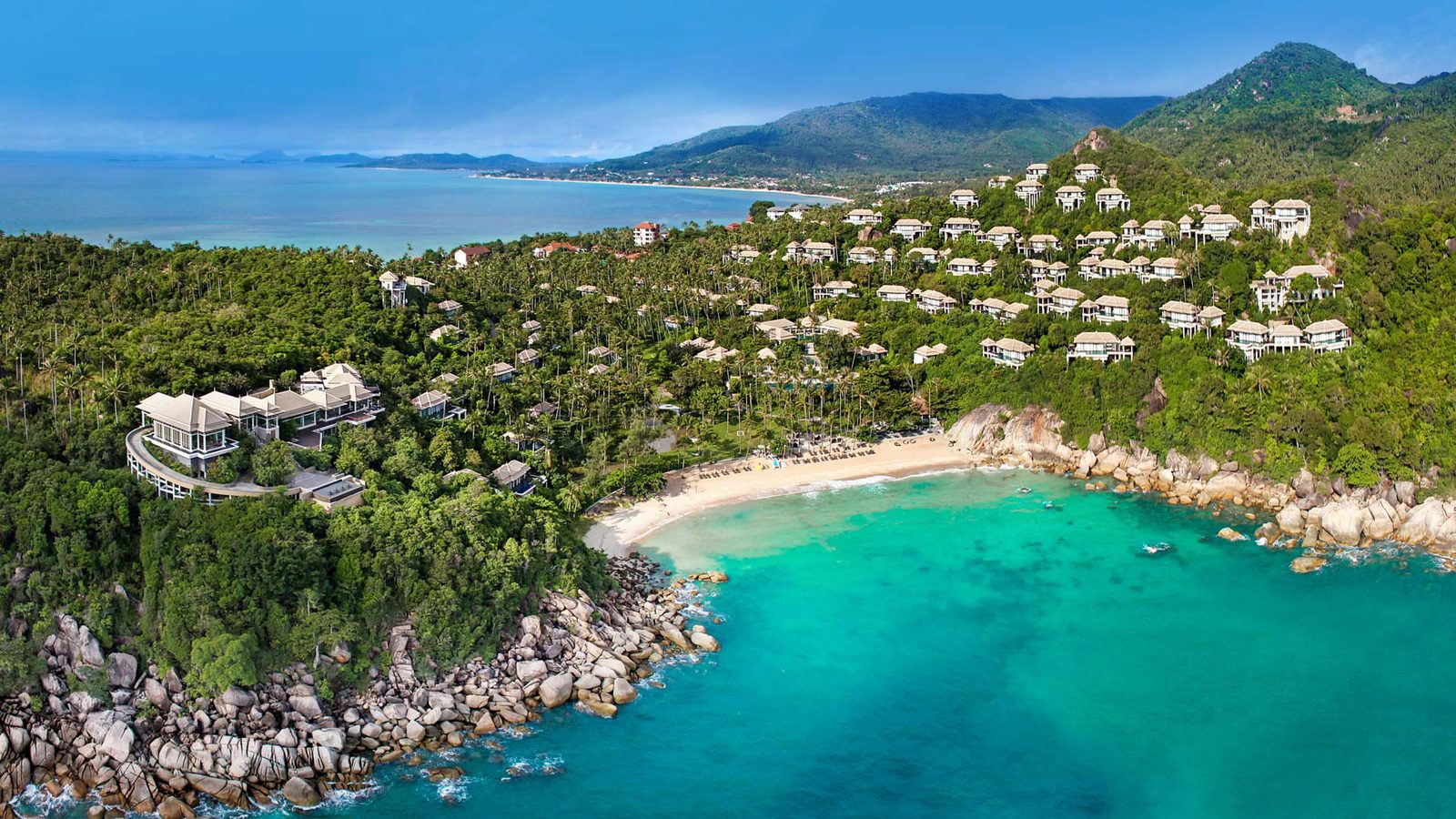 Aerial view of Banyan Tree Samui, with pool villas on the hillside around its private bay at Lamai