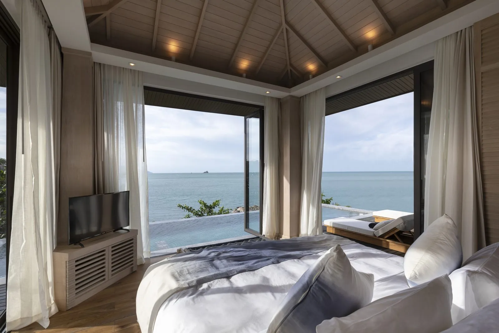 Ocean View Pool Villa bedroom with sea view at Cape Fahn Hotel, Samui