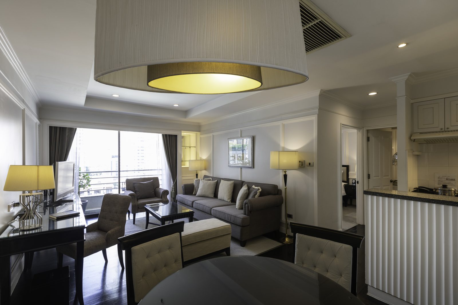 One Bedroom Suite living and dining area with kitchenette at Cape House Hotel Bangkok
