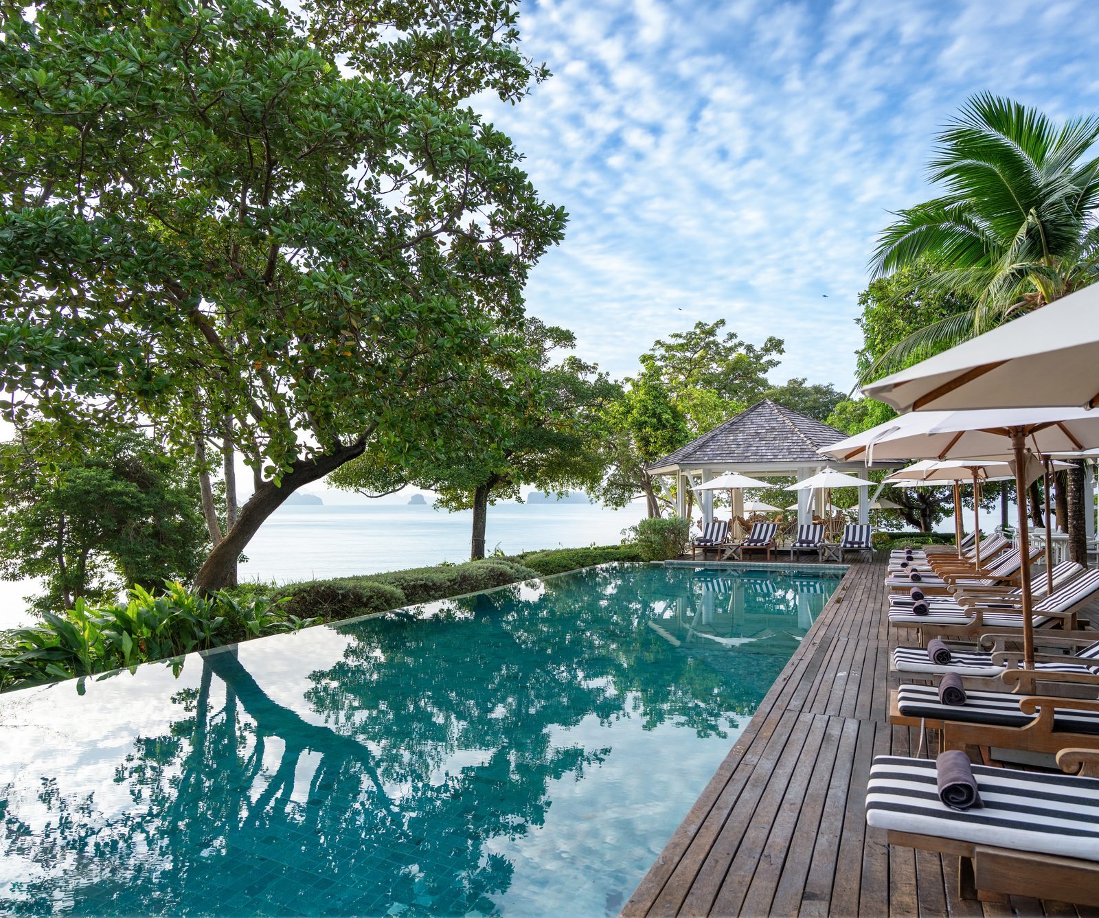 Swimming pool with timber deck and sun loungers at Cape Kudu Hotel, Koh Yao Noi