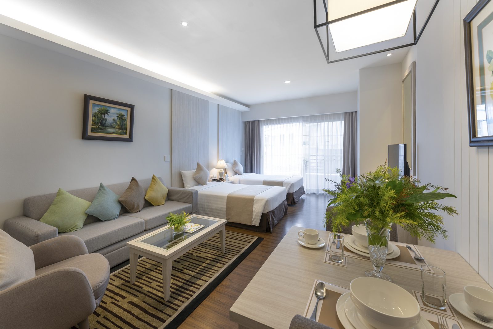 Deluxe Studio with sofa, dining table and twin beds at Cape Racha Hotel, Sriracha