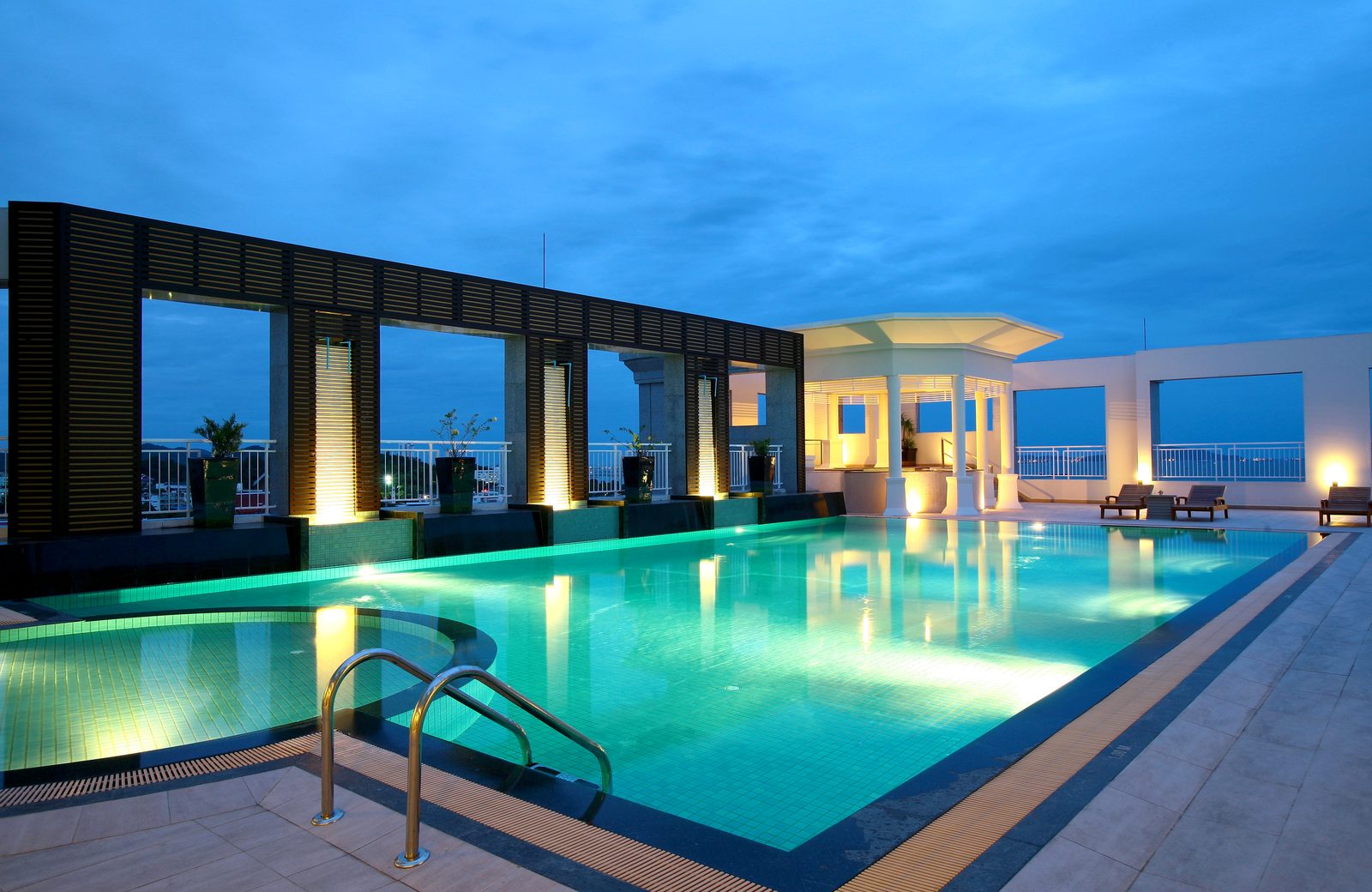 Rooftop swimming pool at dusk at Cape Racha Hotel, Sriracha
