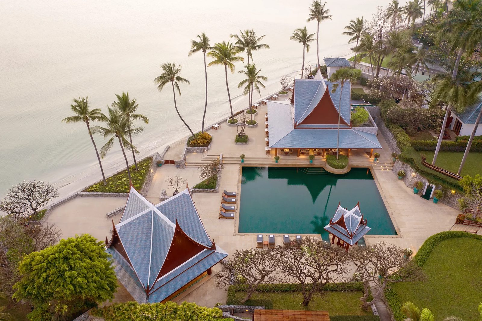 Aerial view of Chiva-Som Hua Hin's beachfront, Thai-style pavilions and pool on the Gulf of Thailand