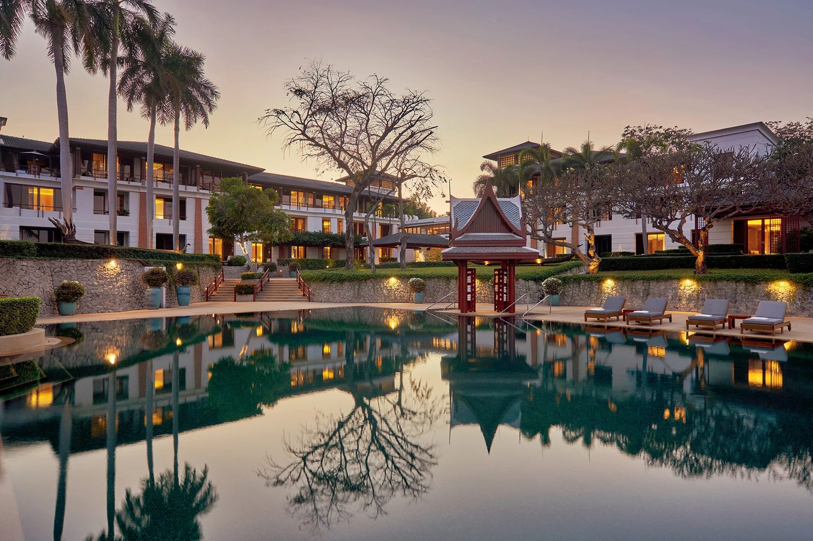 Outdoor pool in front of the ocean wings at Chiva-Som Hua Hin at dusk