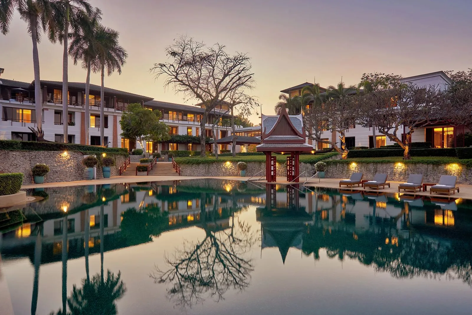 Outdoor pool in front of the ocean wings at Chiva-Som Hua Hin at dusk