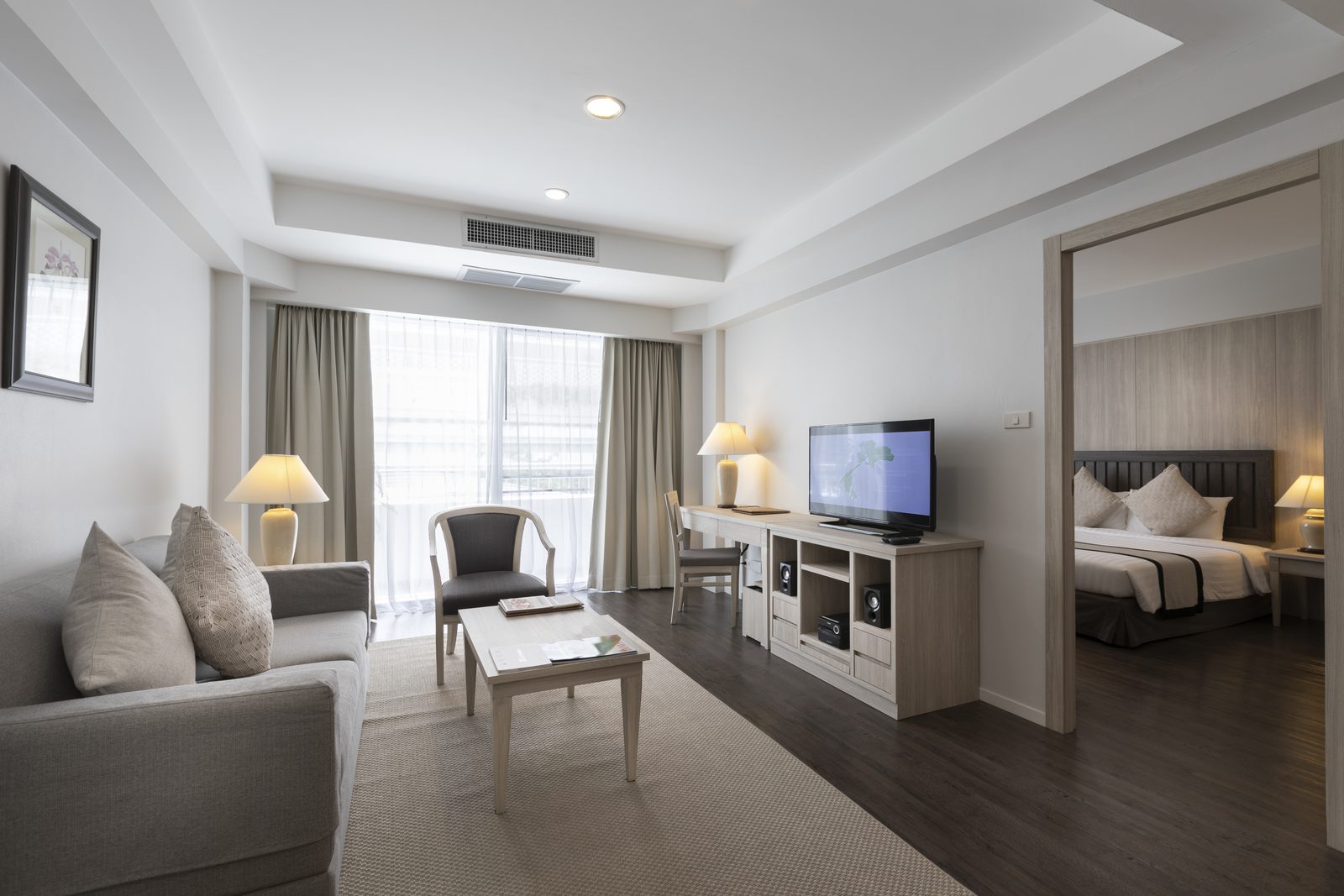 One Bedroom Suite living room with the bedroom beyond at Classic Kameo Hotel, Sriracha