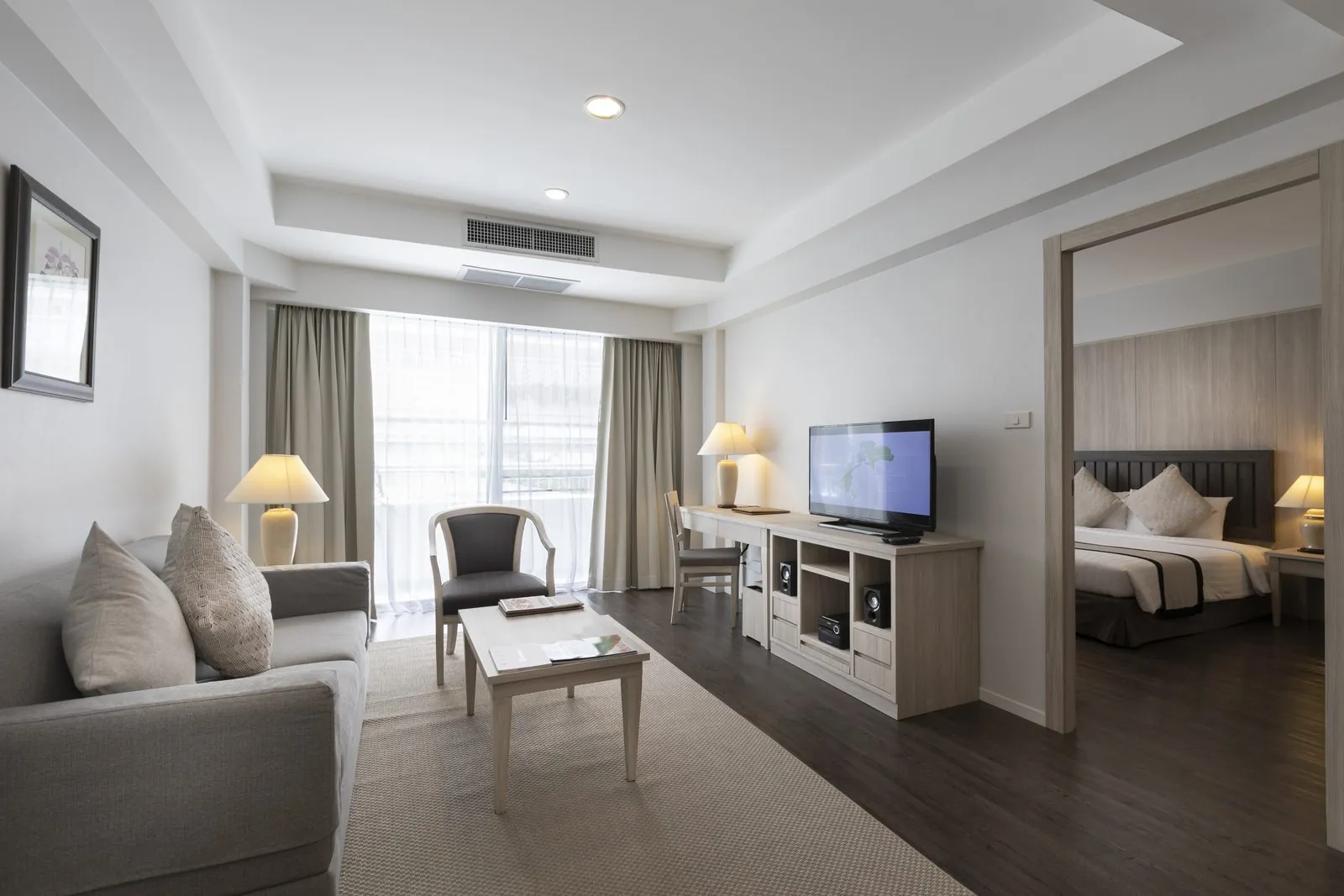 One Bedroom Suite living room with the bedroom beyond at Classic Kameo Hotel, Sriracha