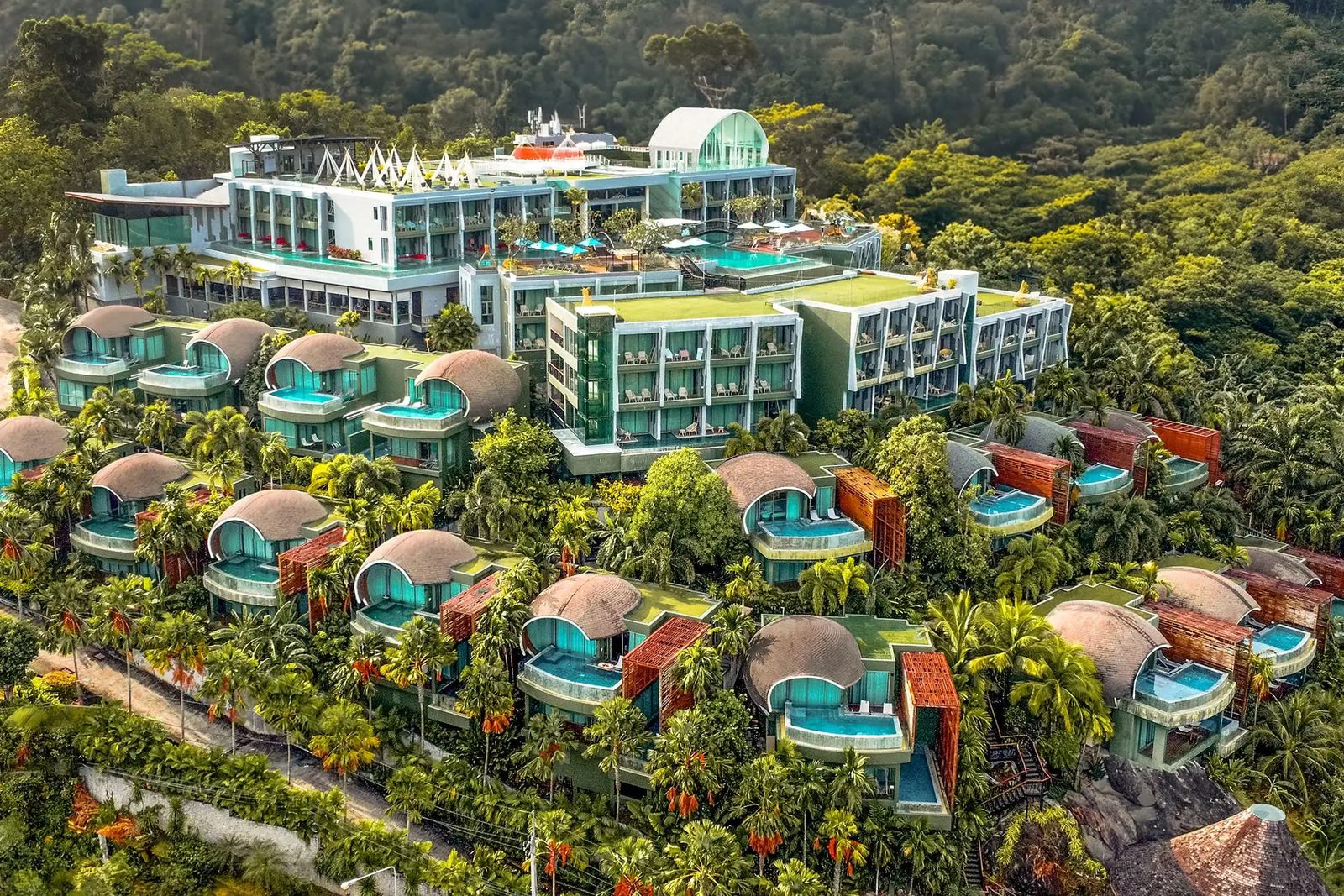 Aerial view of Crest Resort & Pool Villas on its forested hilltop above Patong, Phuket