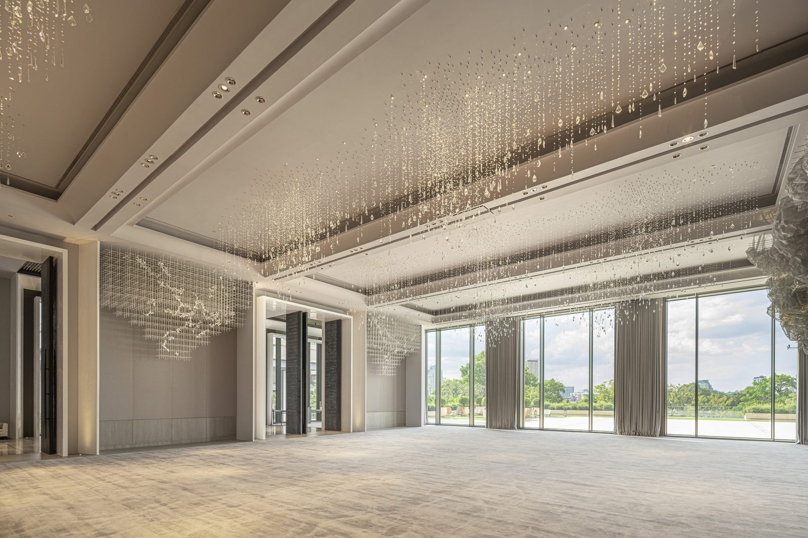 Ballroom with crystal chandeliers and floor-to-ceiling windows at Four Seasons Hotel Bangkok