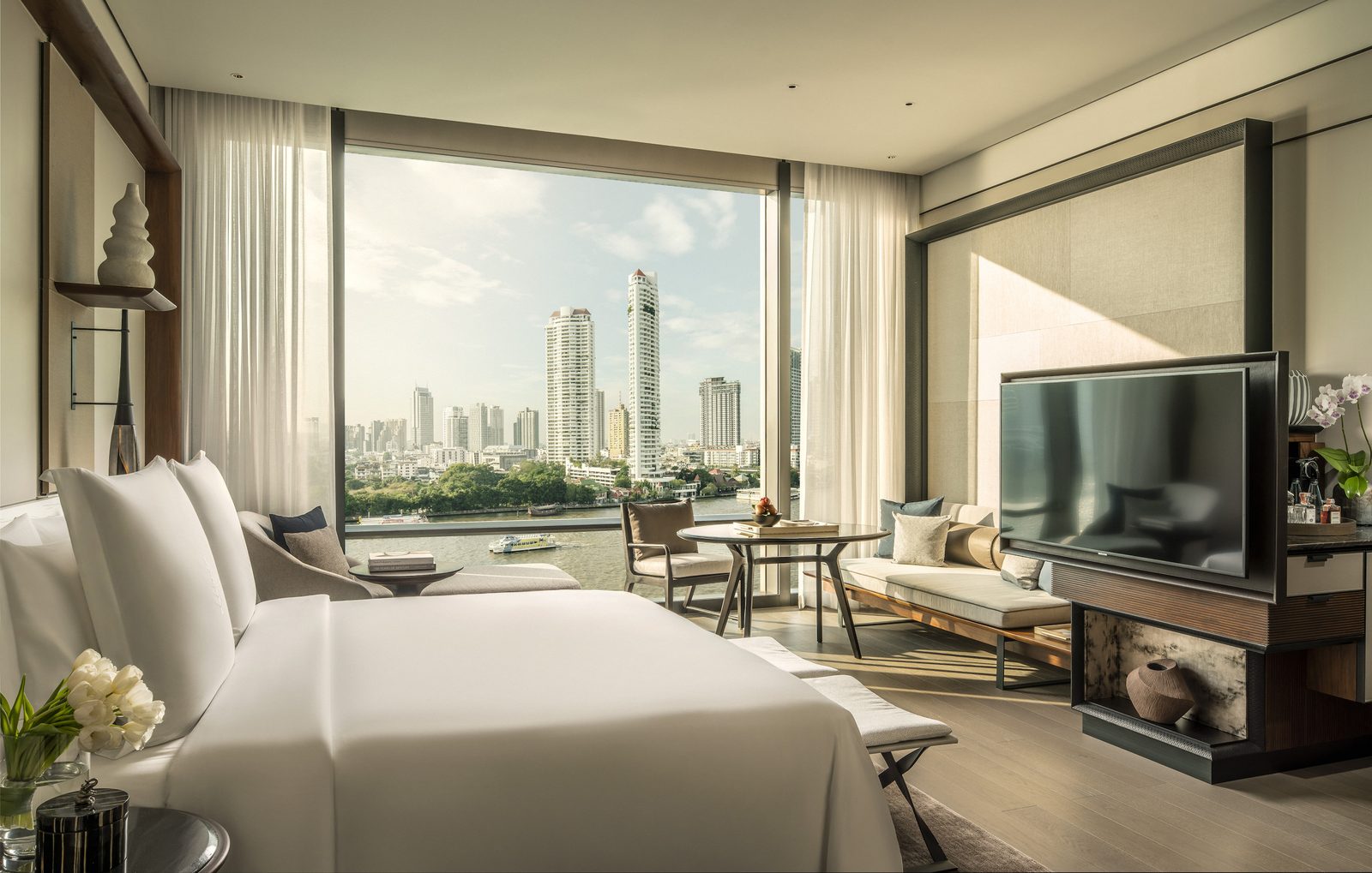 Guest room at Four Seasons Hotel Bangkok with floor-to-ceiling windows over the Chao Phraya River