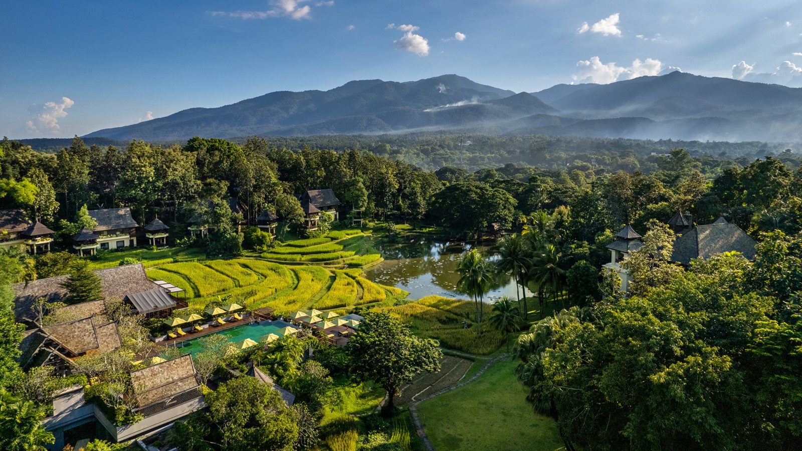 Aerial view of Four Seasons Resort Chiang Mai, its rice terraces and the mountains of the Mae Rim Valley