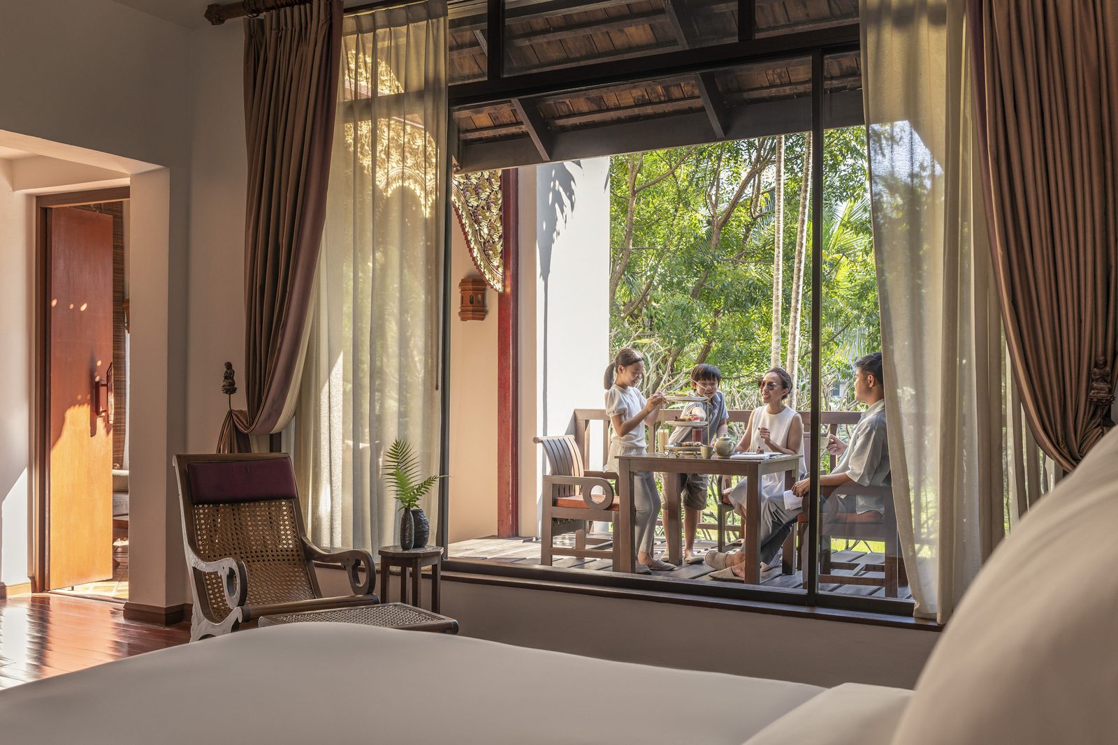 Guest bedroom opening onto a terrace at Four Seasons Resort Chiang Mai