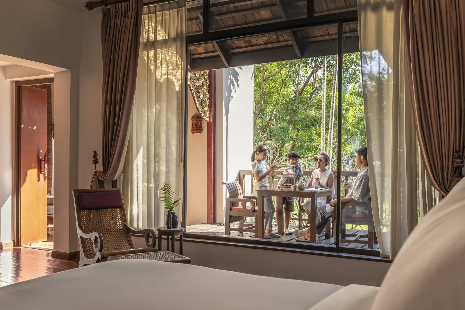 Guest bedroom opening onto a terrace at Four Seasons Resort Chiang Mai