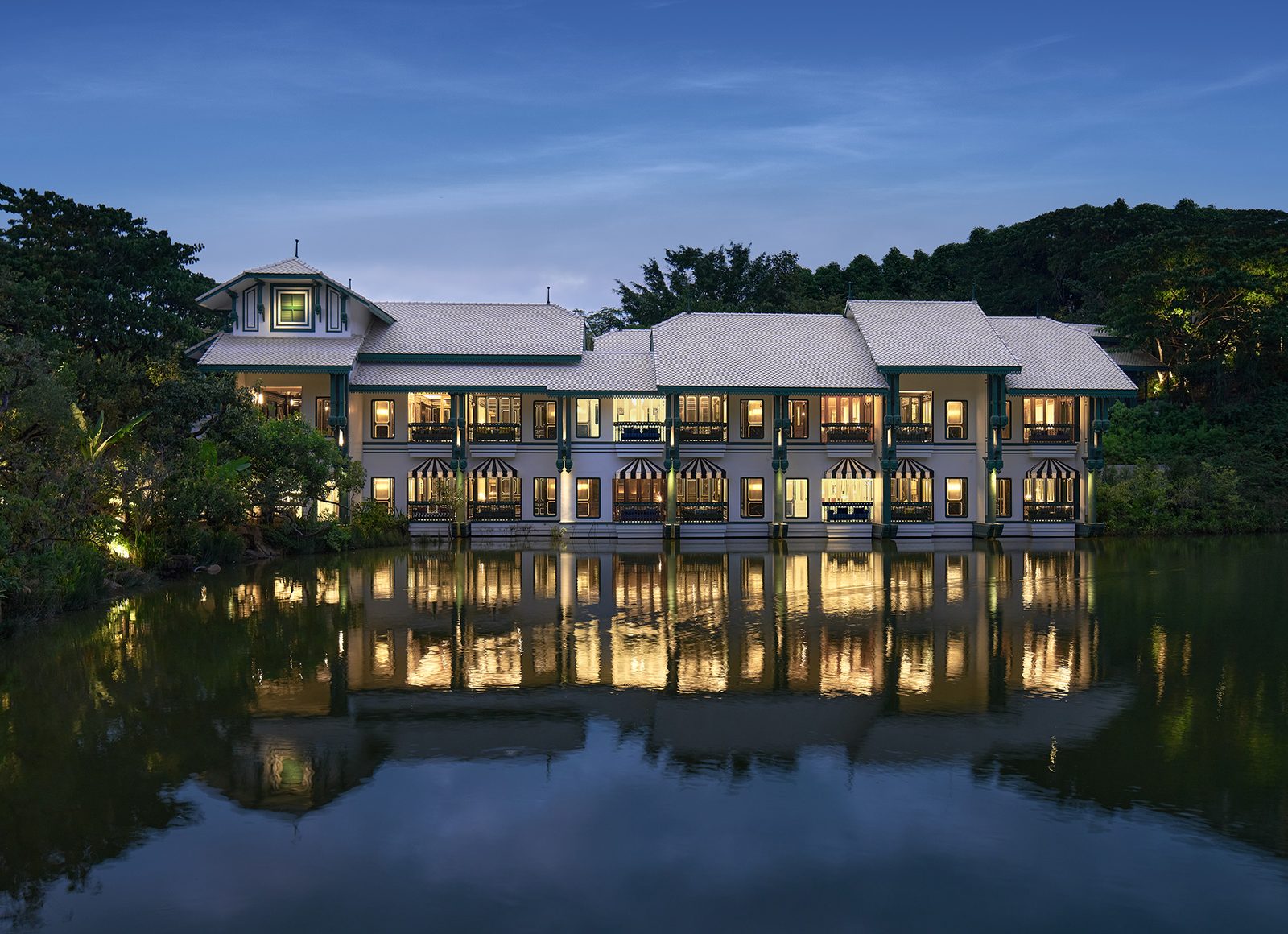 InterContinental Khao Yai Resort lit at dusk across Swan Lake