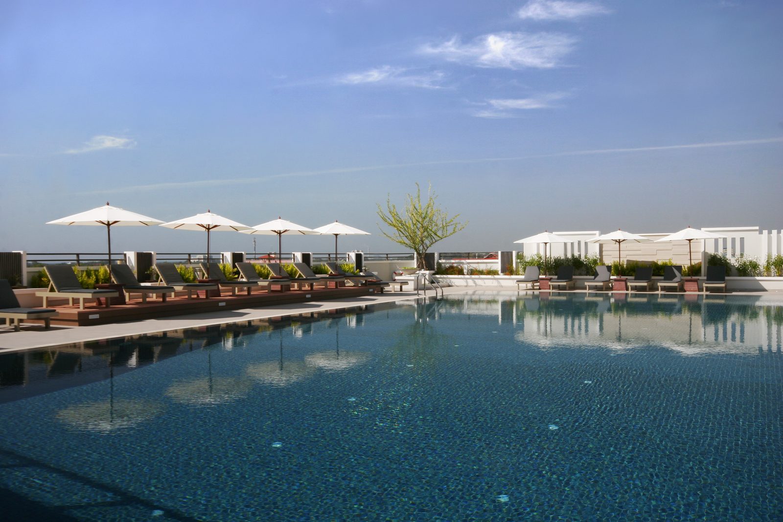 Rooftop swimming pool with sun loungers at Kameo Grand Hotel, Rayong