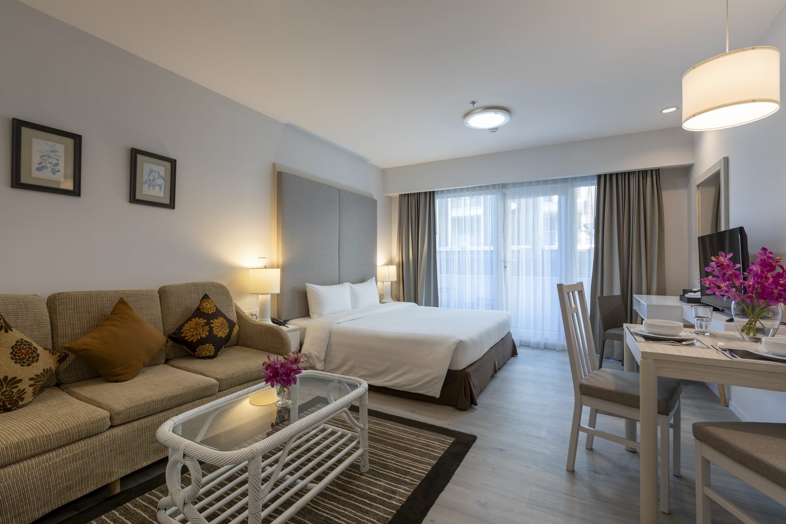 Studio Suite with bed, sofa and dining table at Kameo Residences, Korat