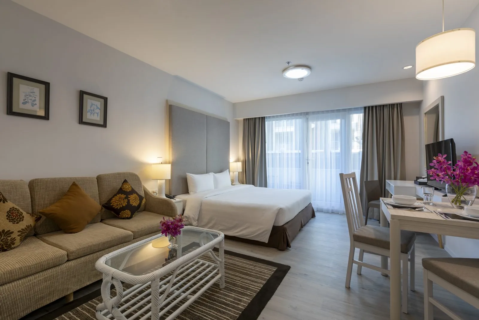 Studio Suite with bed, sofa and dining table at Kameo Residences, Korat