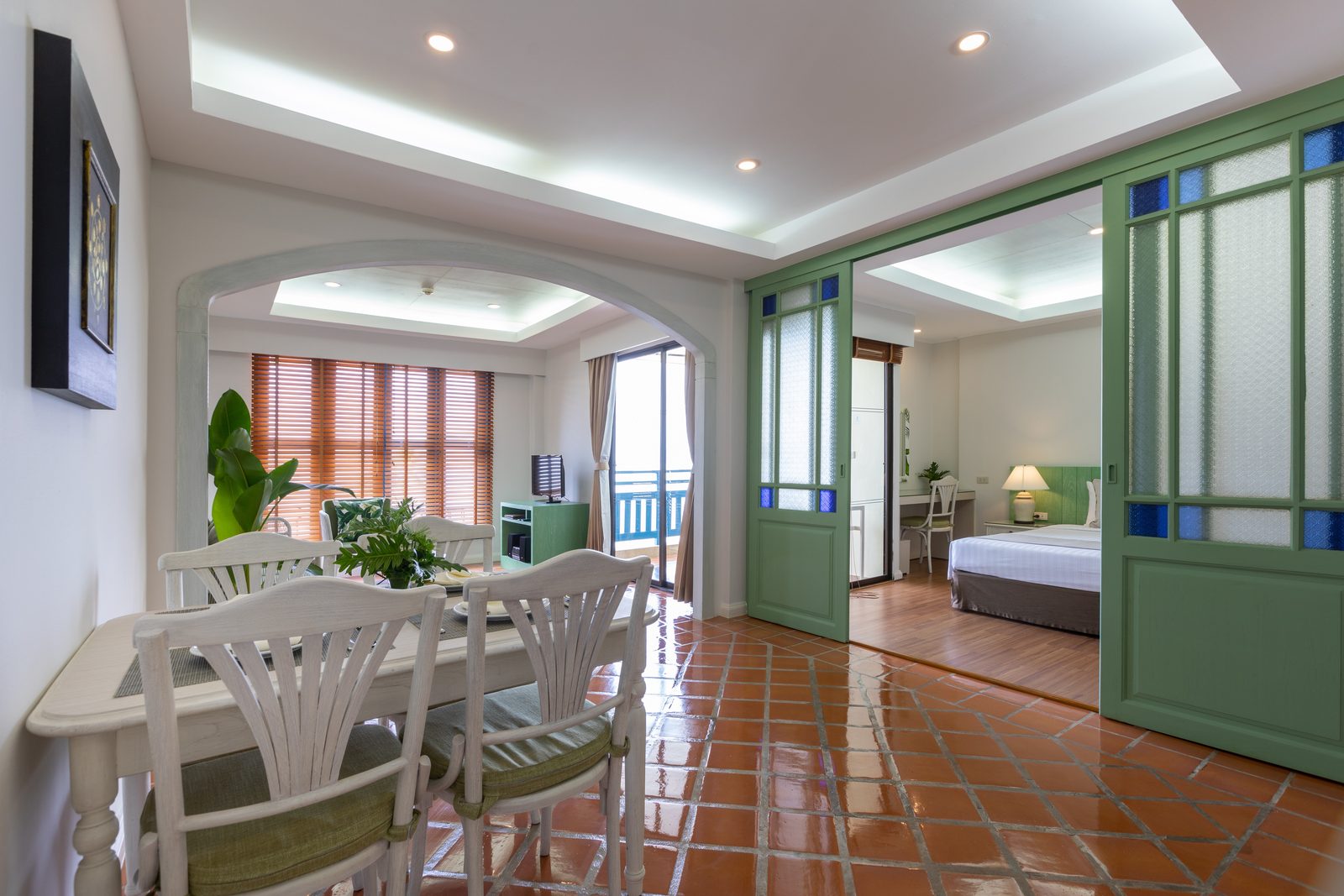 One-bedroom unit dining and living area opening to the bedroom at Kantary Bay Hotel, Phuket