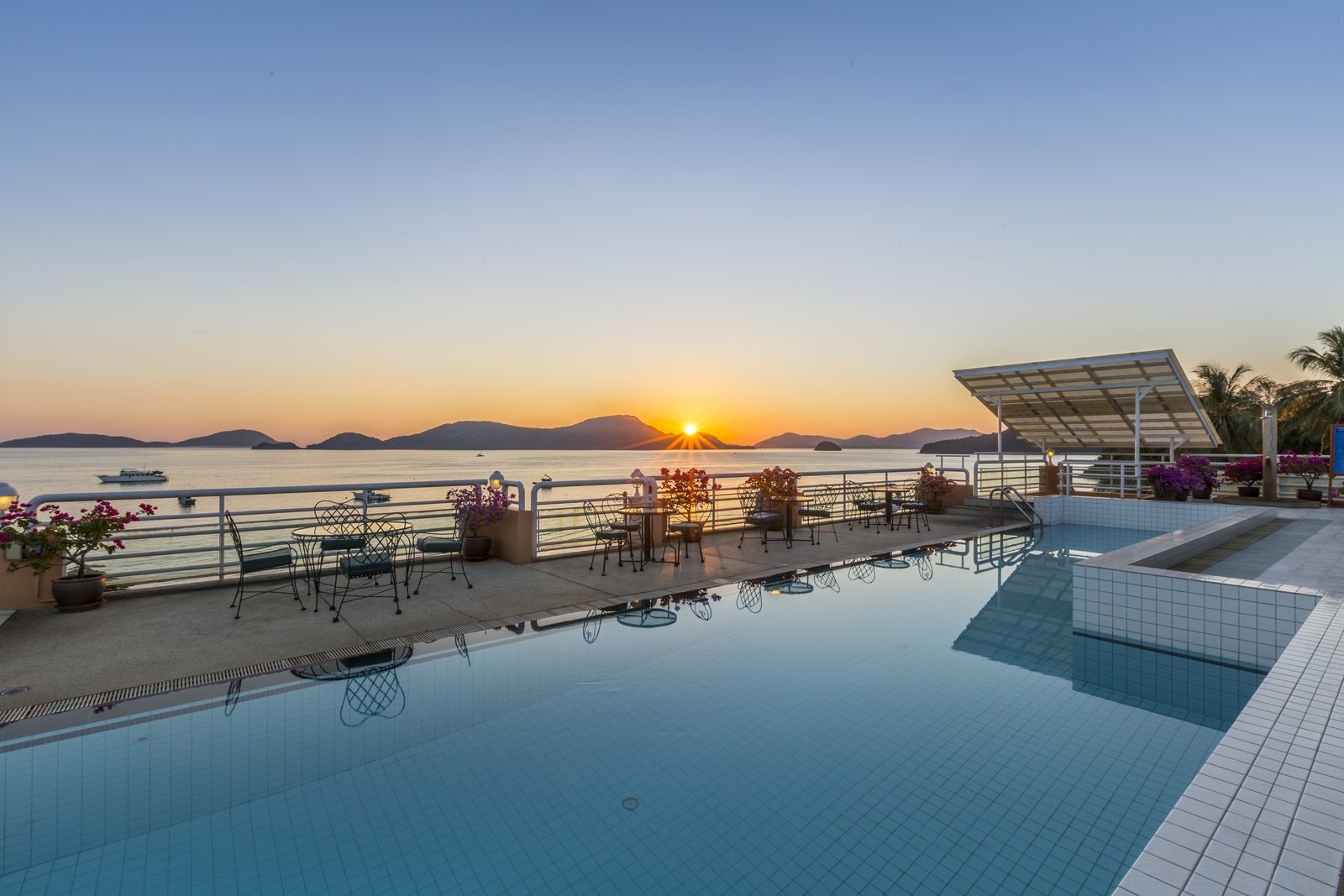 Swimming pool overlooking Panwa Bay at sunset at Kantary Bay Hotel, Phuket