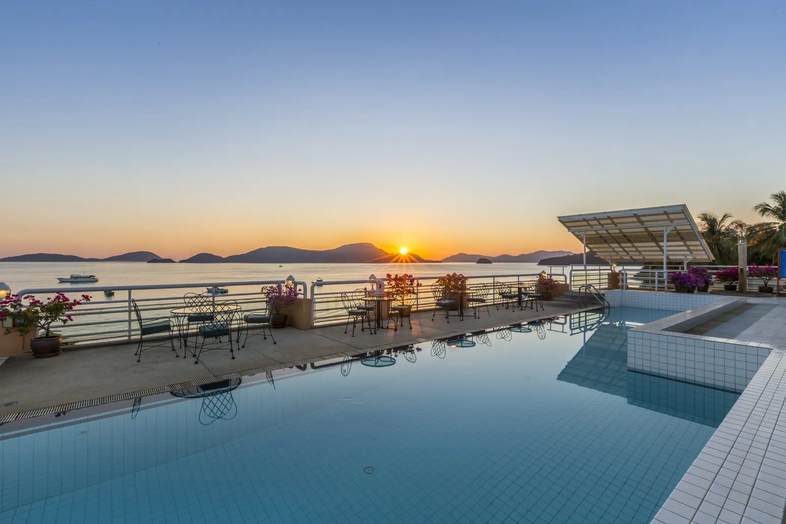 Swimming pool overlooking Panwa Bay at sunset at Kantary Bay Hotel, Phuket