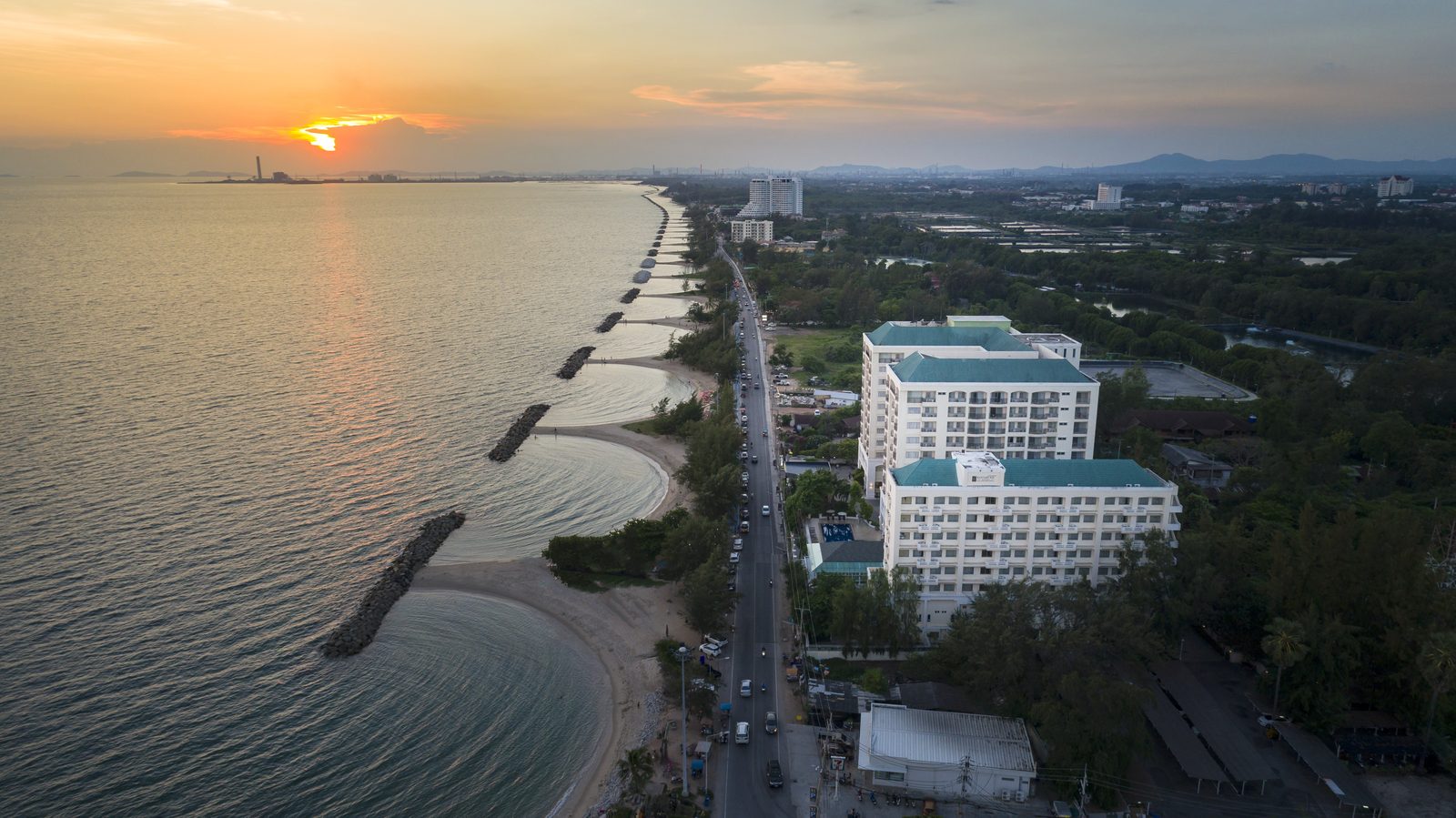 Aerial view of Kantary Bay Hotel beside Beach Road and Saengchan Beach, Rayong, at sunset