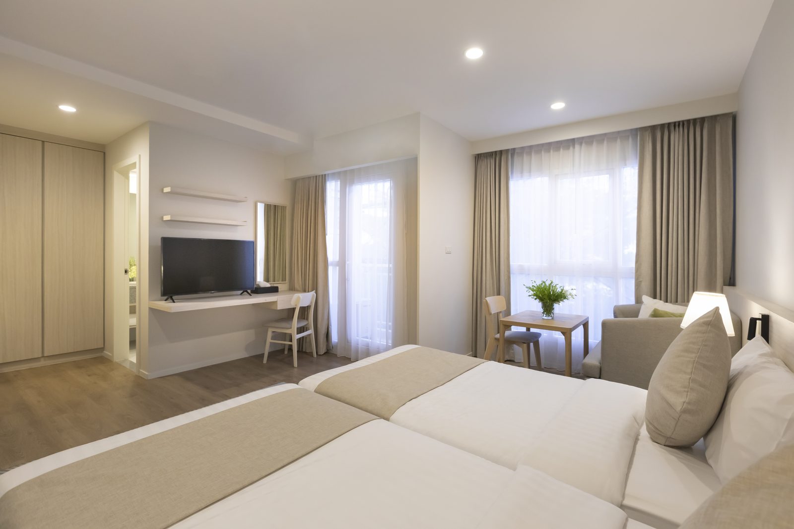 Deluxe room with twin beds and seating area at Kantary Hotel, Ban Chang