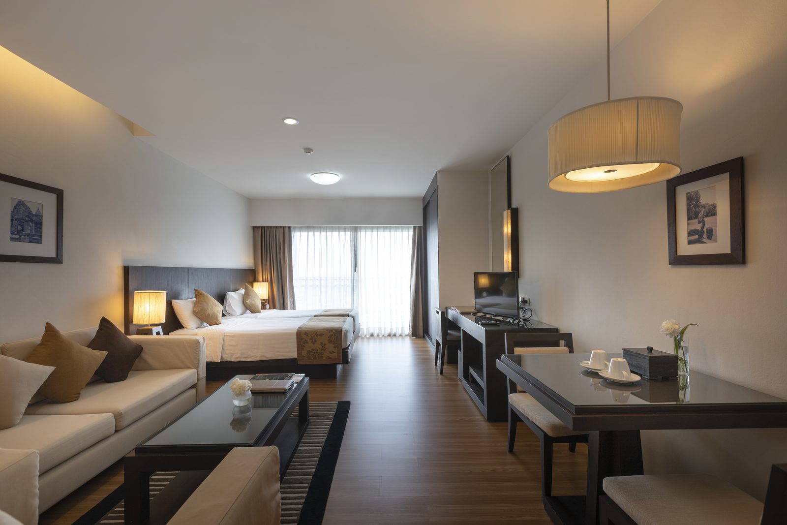 Studio Suite with bed, sofa and dining table at Kantary Hotel, Kabinburi