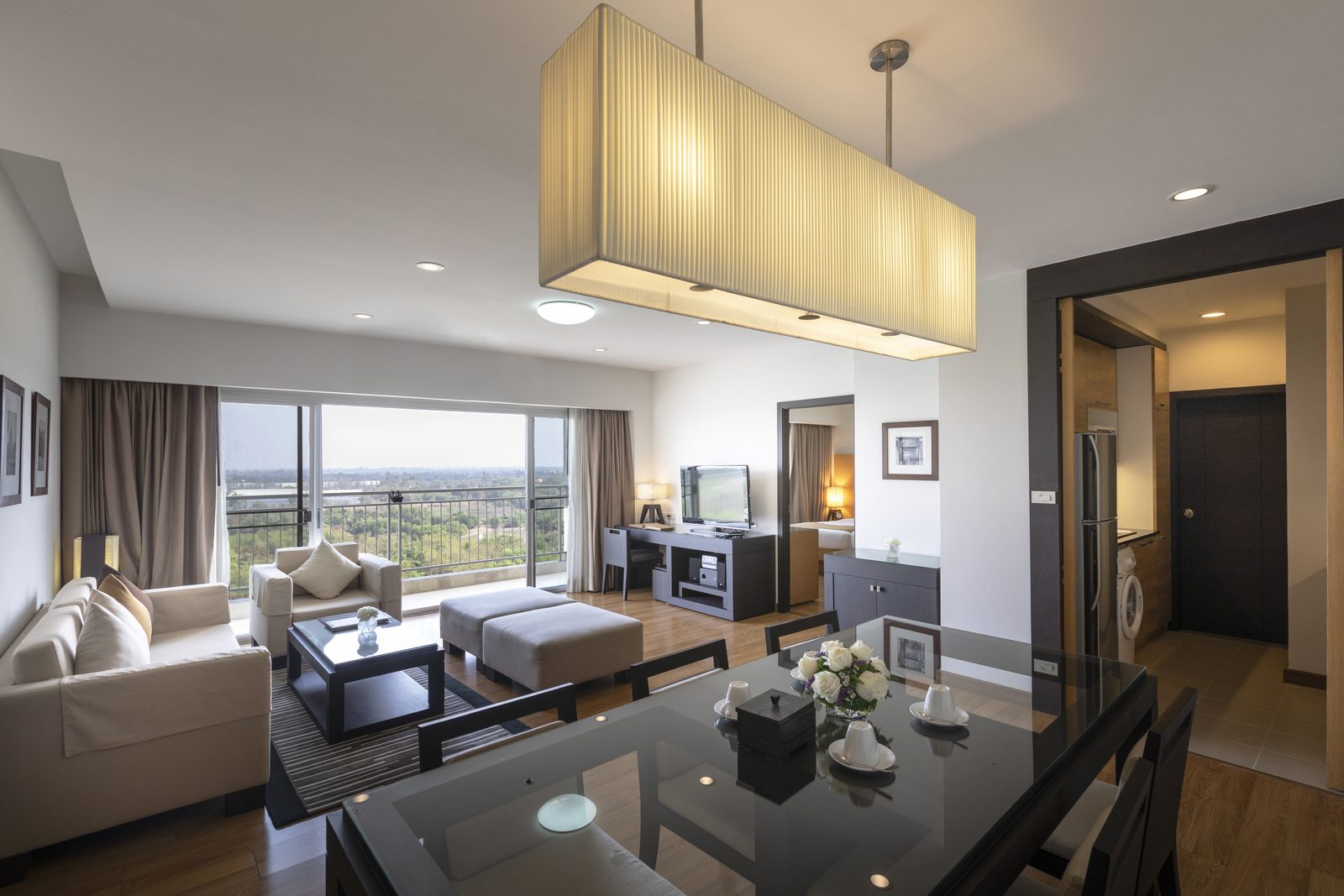 Two Bedroom Suite living and dining room with balcony at Kantary Hotel, Kabinburi