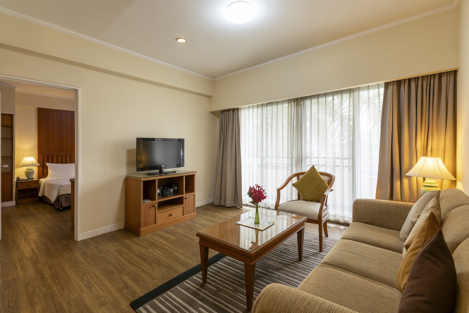 One Bedroom Suite living room with view into the bedroom at Kantary House Hotel, Bangkok