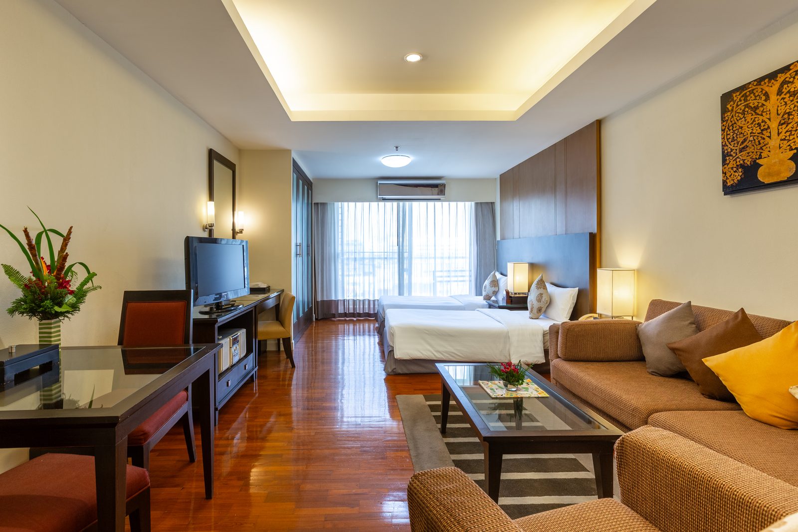 Studio Suite with beds, sofa and dining table at Kantary House Hotel, Bangkok