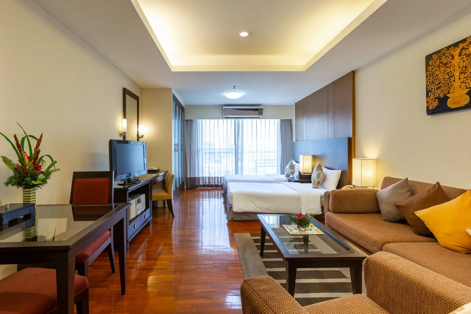Studio Suite with beds, sofa and dining table at Kantary House Hotel, Bangkok