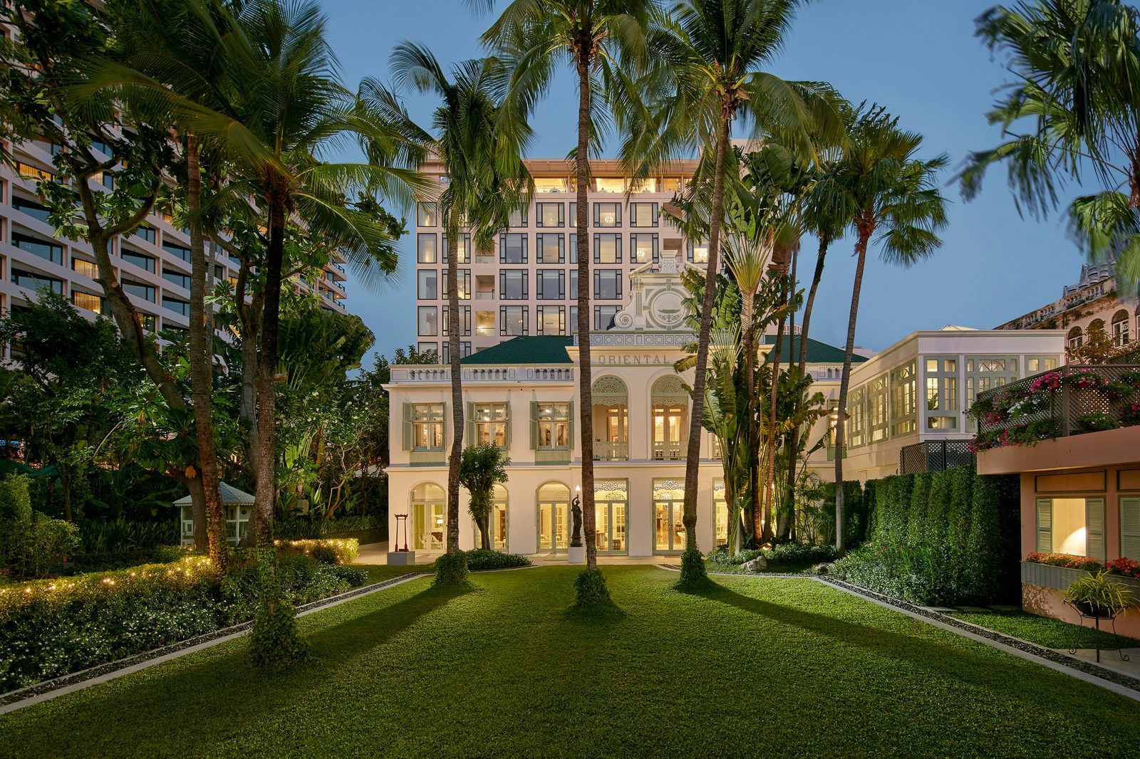 The historic Authors' Wing of Mandarin Oriental, Bangkok among tall palms and gardens