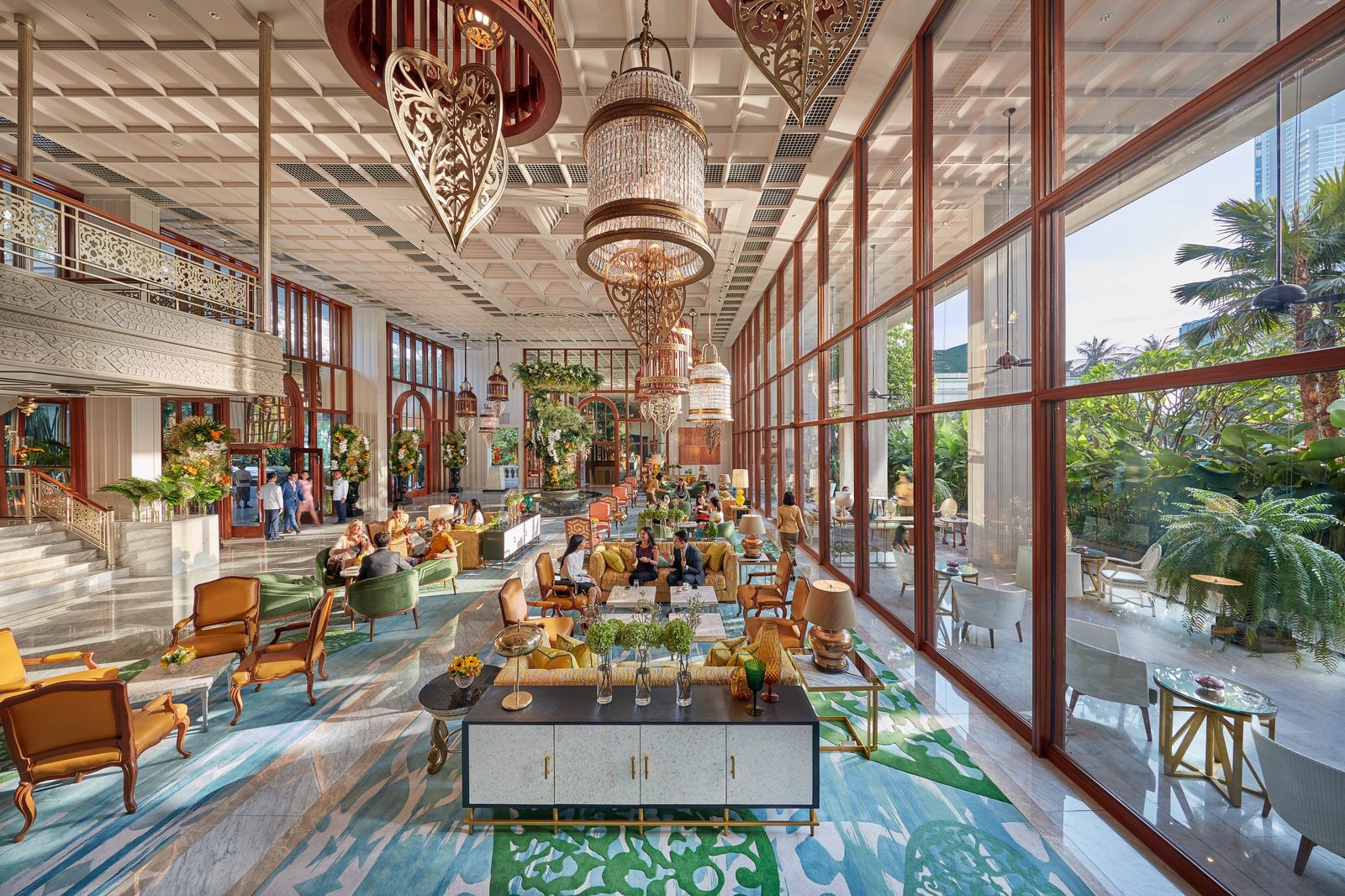 High-ceilinged lobby with chandeliers and garden windows at Mandarin Oriental, Bangkok