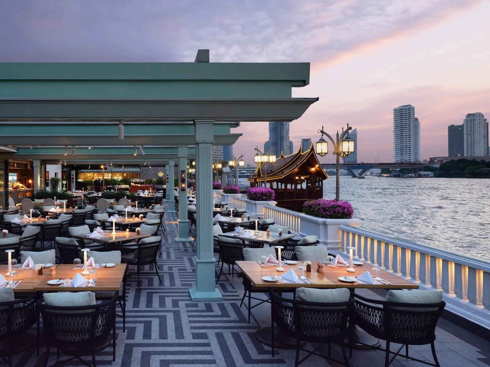 Riverside Terrace restaurant at dusk beside the Chao Phraya at Mandarin Oriental, Bangkok