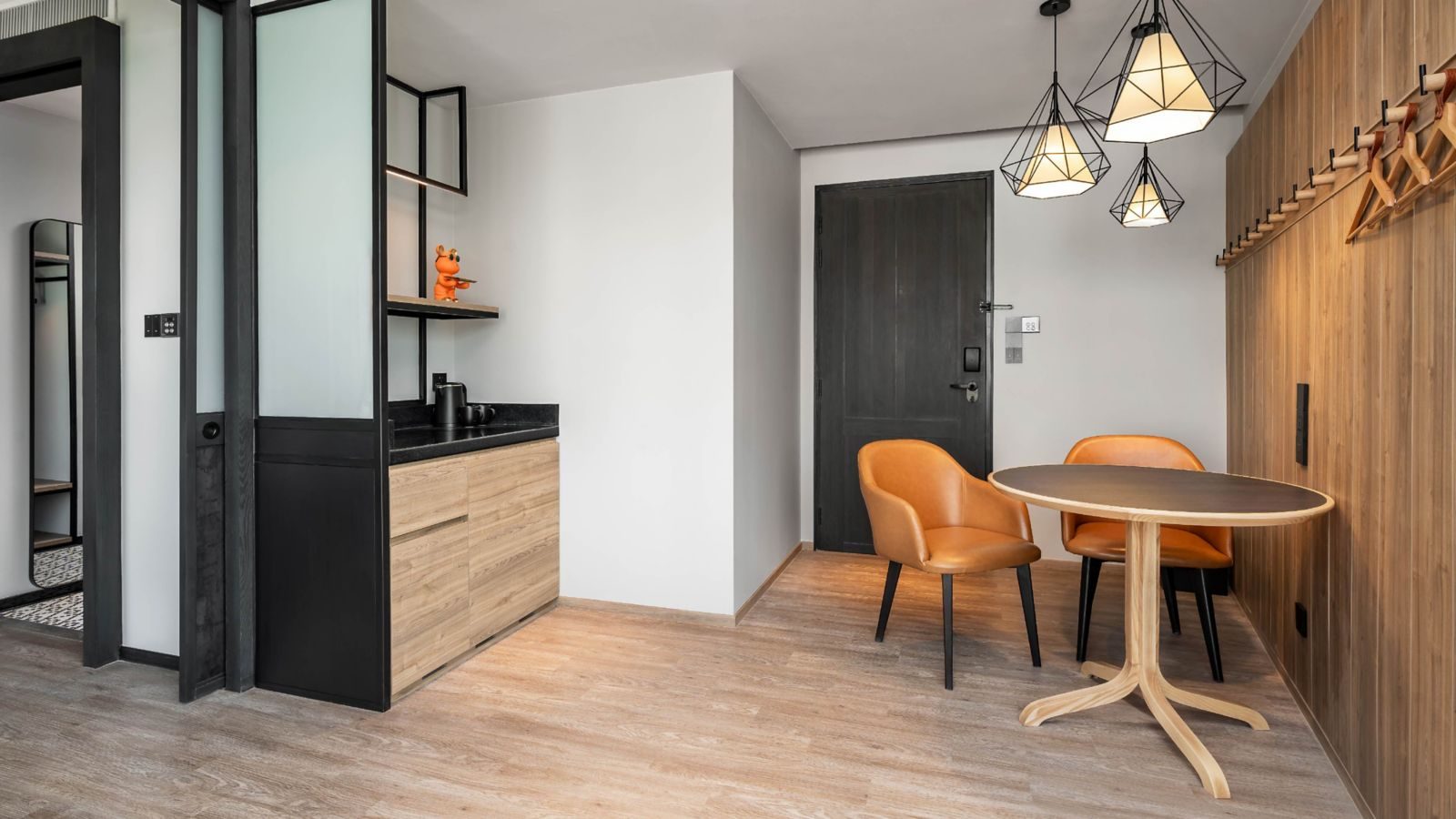 Living and work area of a Moxy Deluxe room at Moxy Bangkok Ratchaprasong