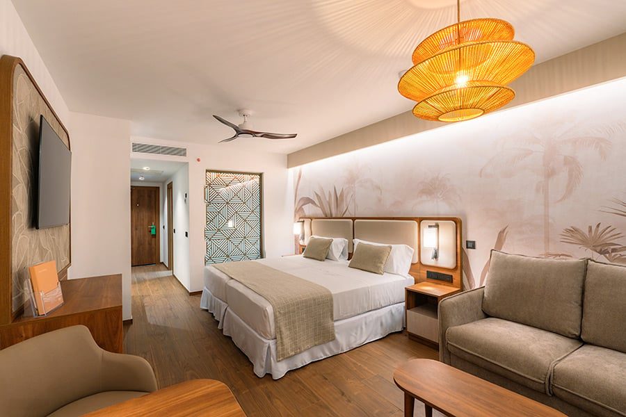 Bedroom and sitting area of a Suite Swim Up in the Elite Club at Hotel Riu Palace Phuket
