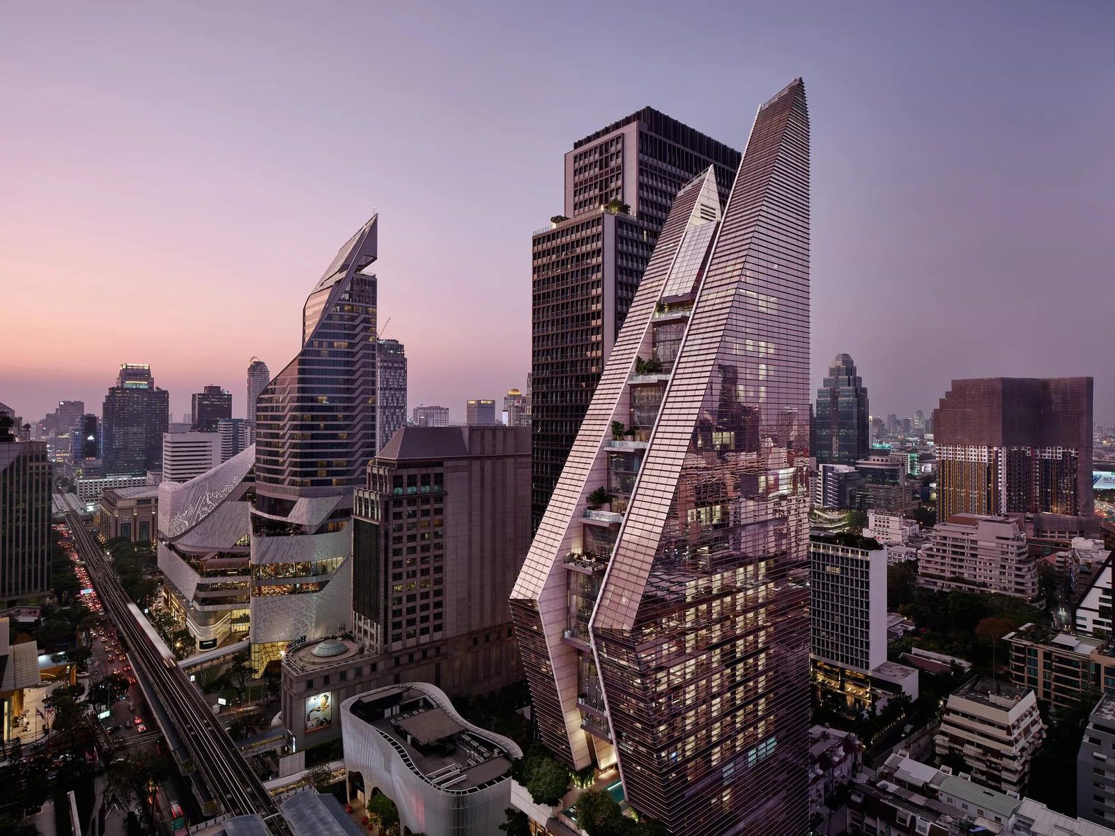 Rosewood Bangkok's 30-storey tower on Ploenchit Road at dusk