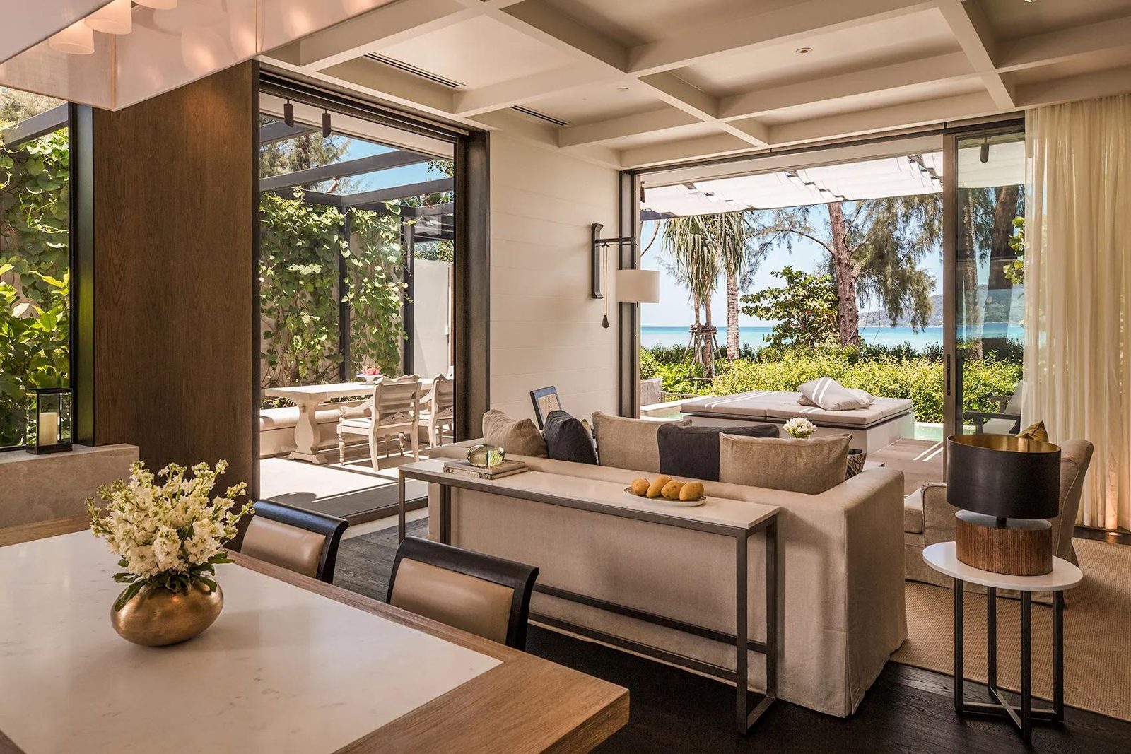 Living room of a Beachfront Pool Villa at Rosewood Phuket, opening to the garden