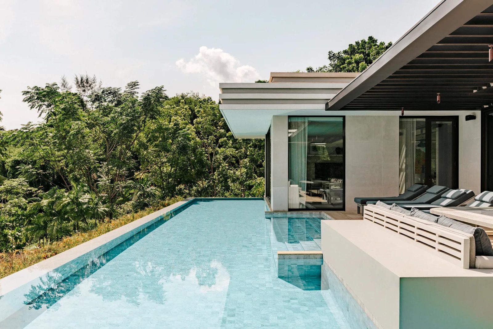 Pool of The Palm House at Rosewood Phuket, above the forest
