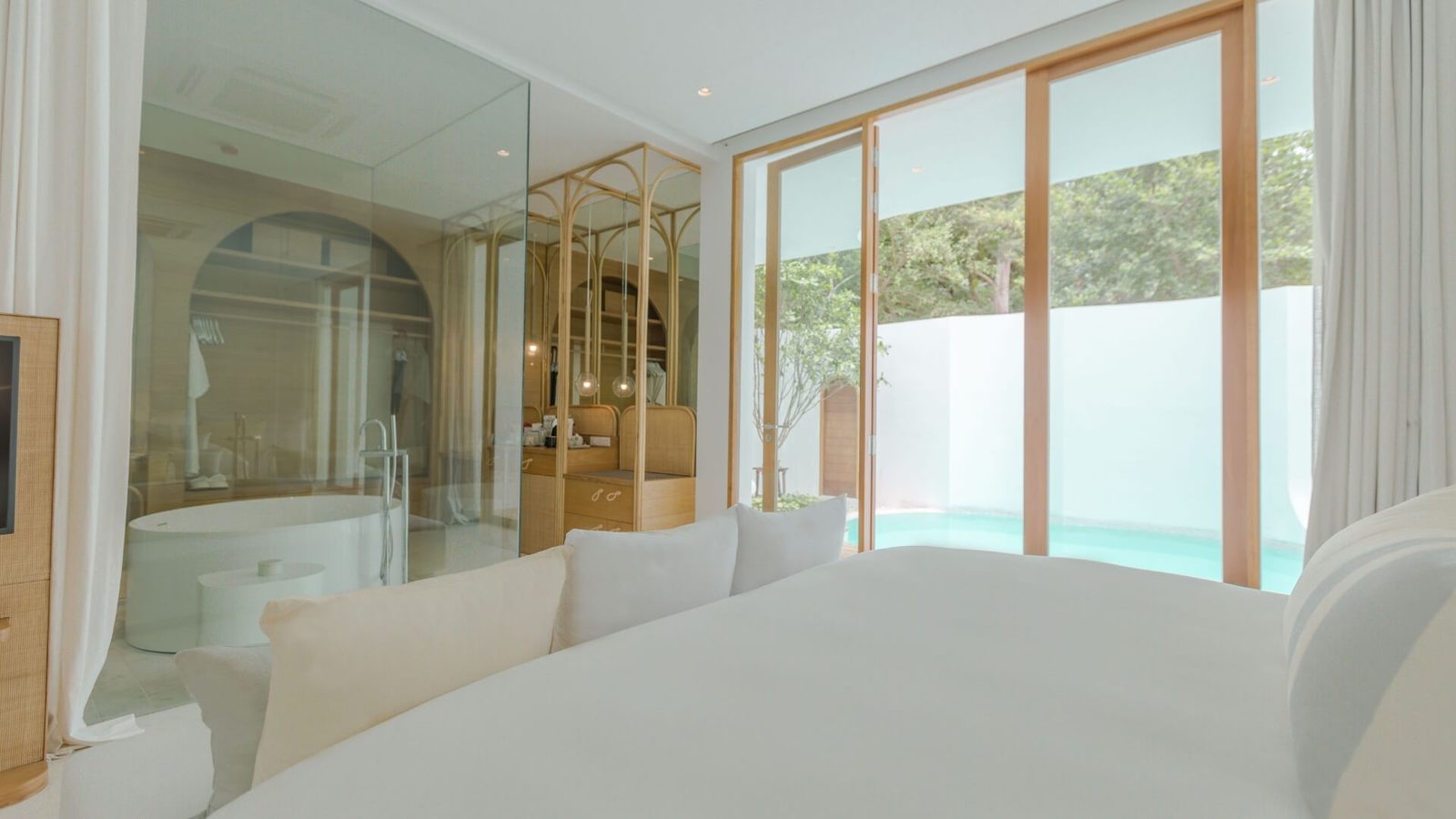 Garden Pool Villa bedroom with a glass-walled bathroom opening onto the private pool at SALA Samui Chaweng Beach Resort