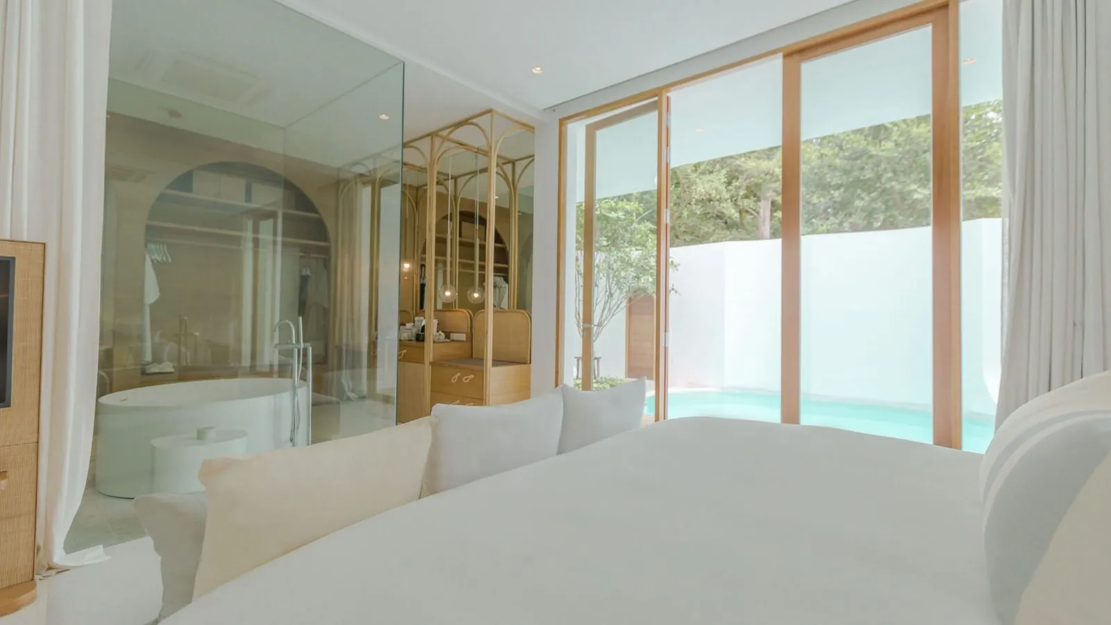 Garden Pool Villa bedroom with a glass-walled bathroom opening onto the private pool at SALA Samui Chaweng Beach Resort