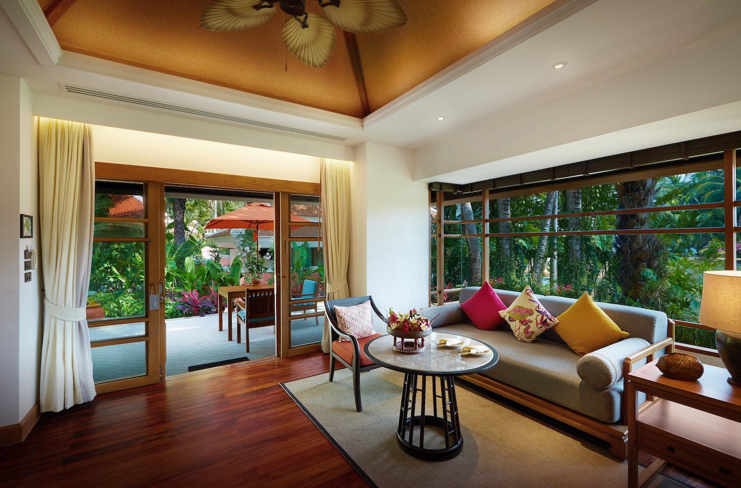 Deluxe Garden Villa living area with timber floors opening onto the garden at Santiburi Koh Samui