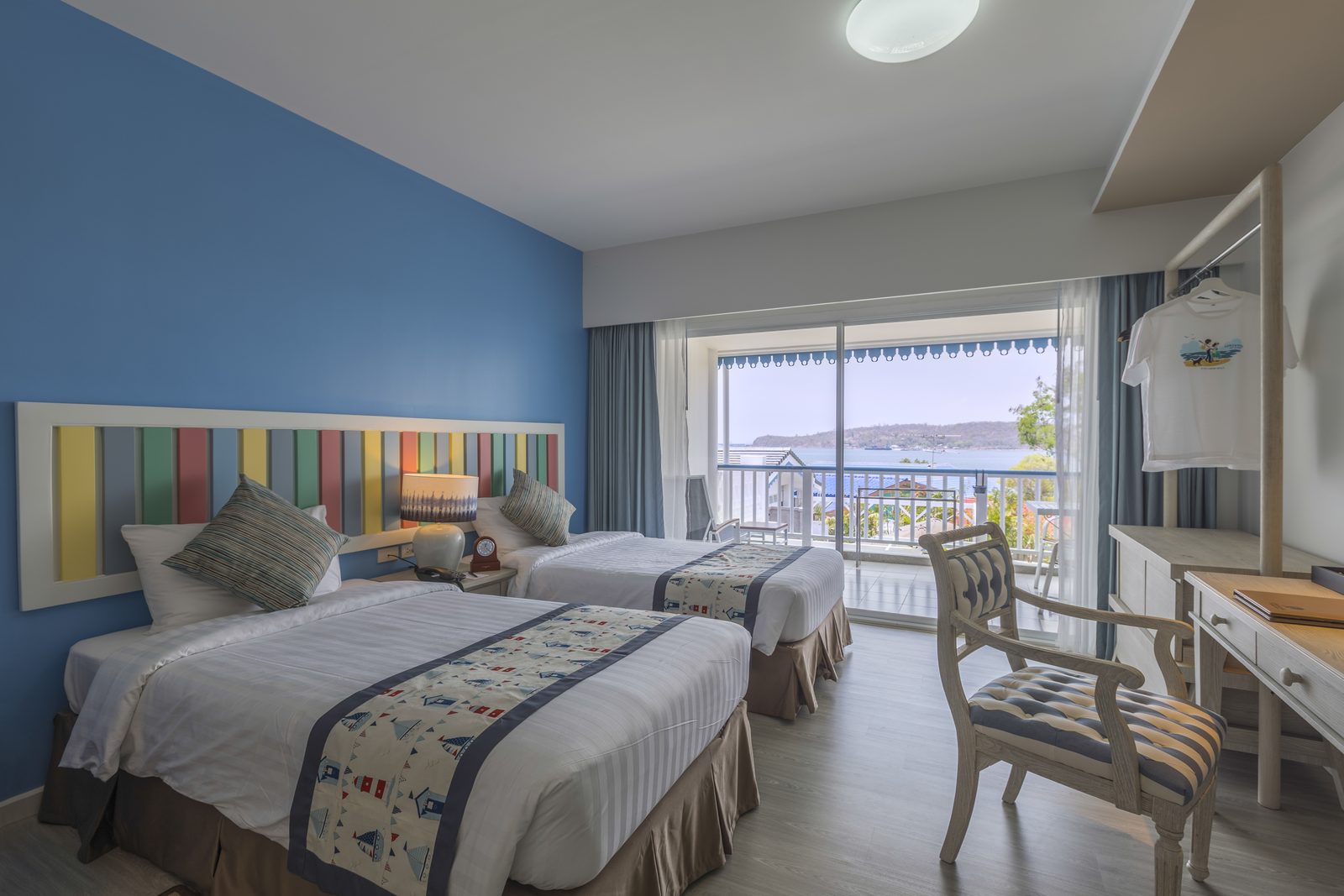 Deluxe room with twin beds and a balcony looking towards the sea at Somewhere Hotel, Koh Sichang