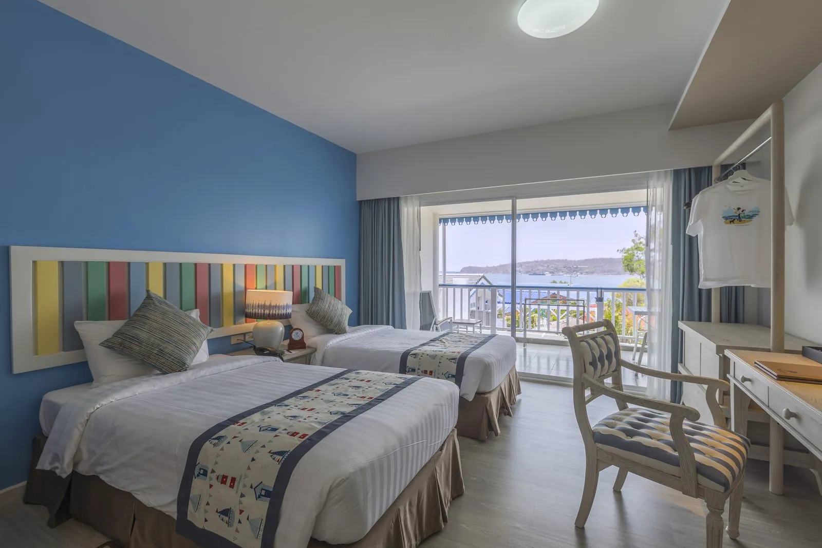Deluxe room with twin beds and a balcony looking towards the sea at Somewhere Hotel, Koh Sichang