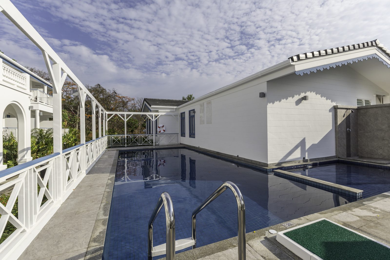 Swimming pool between the white guest wings of Somewhere Hotel, Koh Sichang