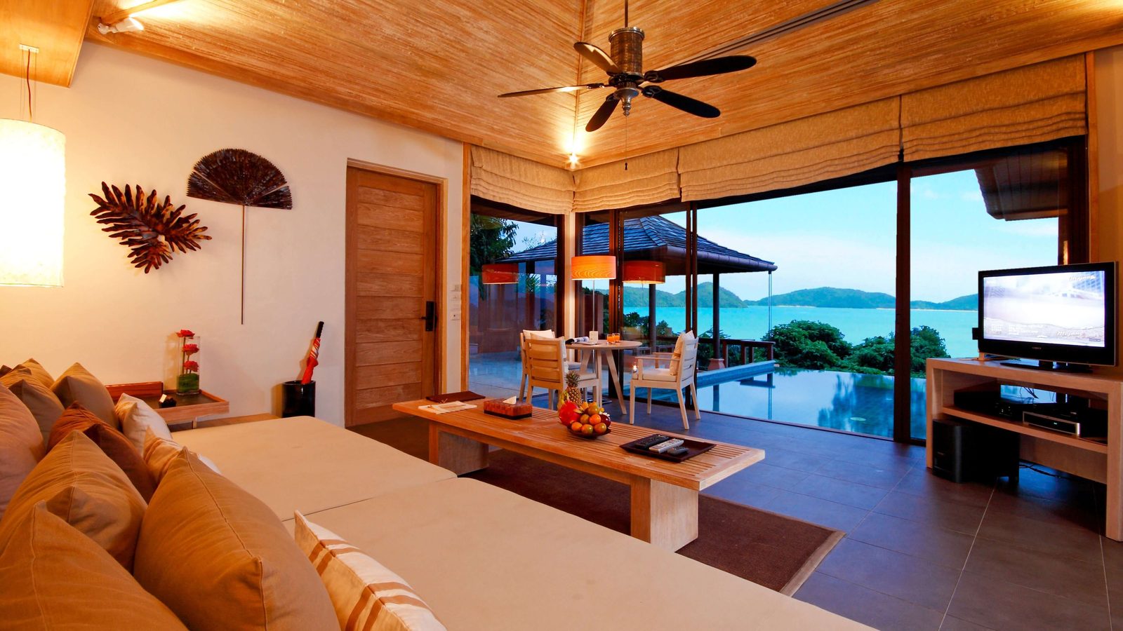 Living room of a Two Bedroom Pool Villa Ocean View at Sri Panwa Phuket, opening to the terrace