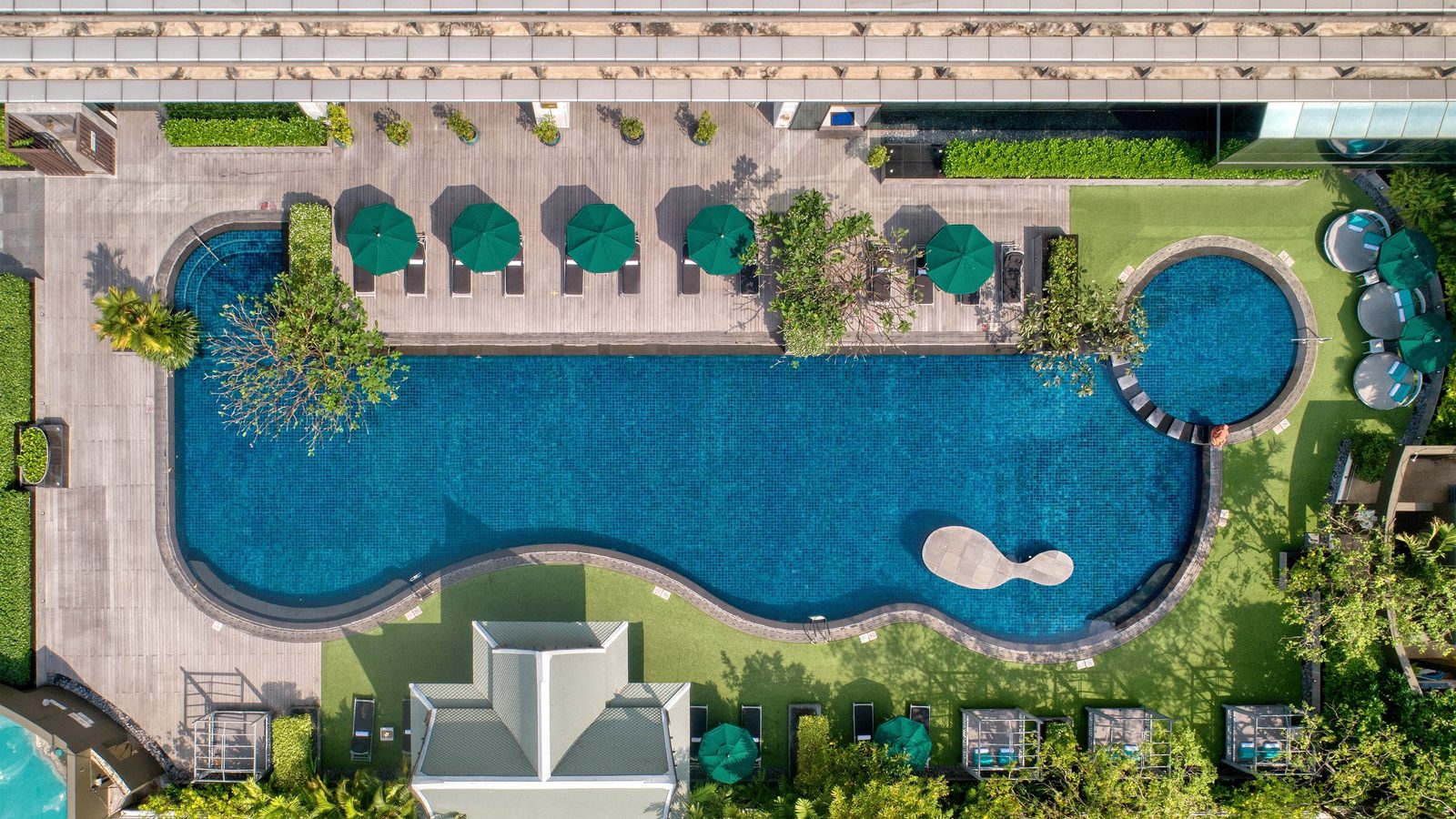 Aerial view of the outdoor swimming pool and garden terrace at The Athenee Hotel, Bangkok