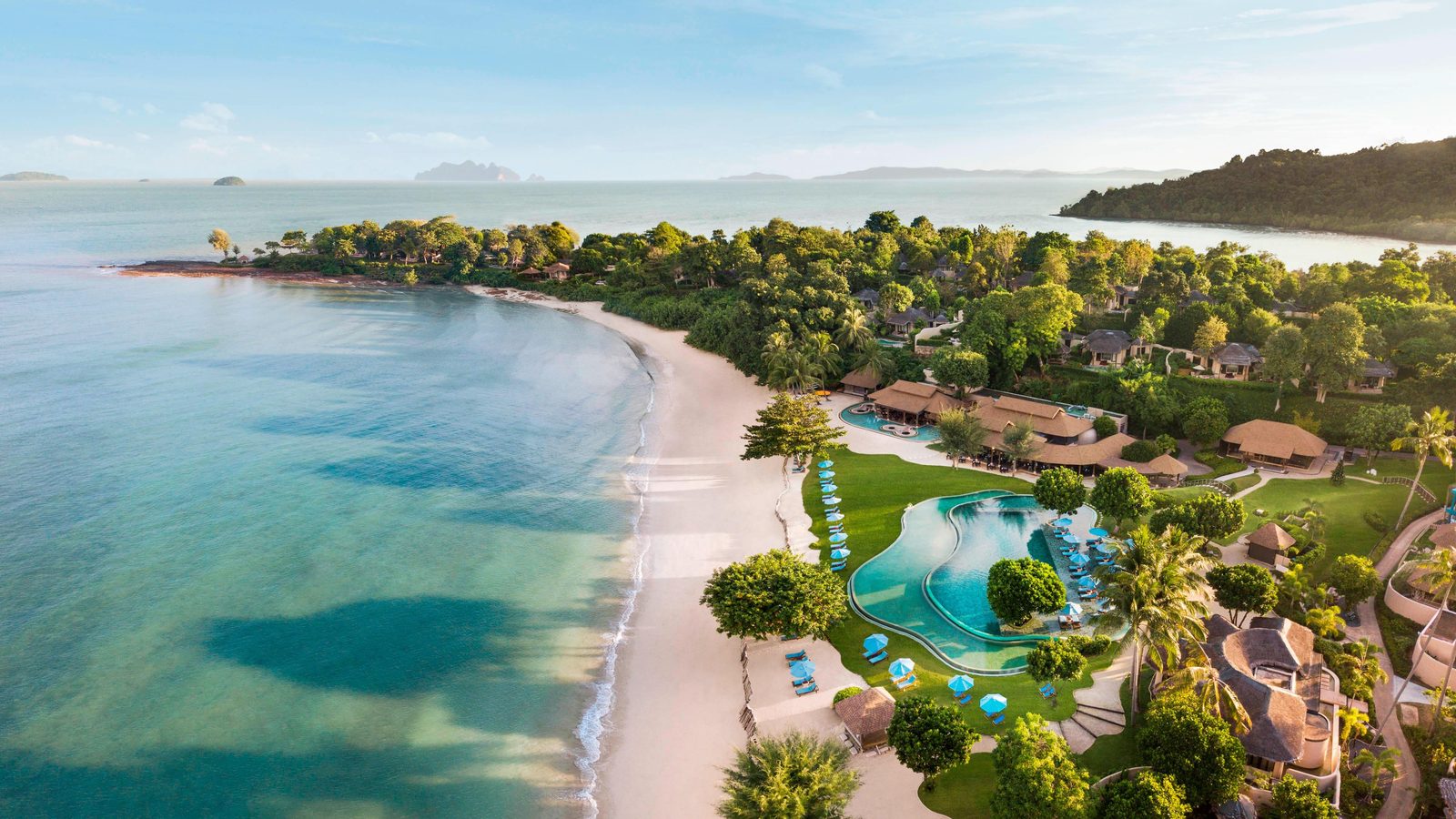 Aerial view of The Naka Island resort, its pool and beach on Naka Yai Island, Phuket
