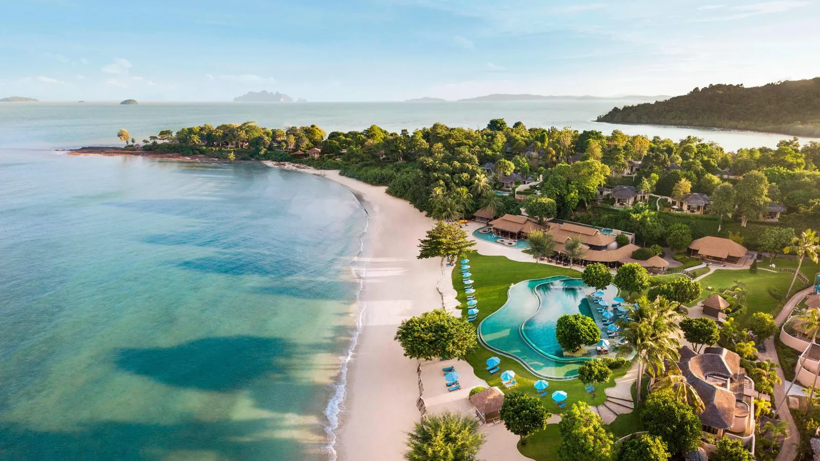 Aerial view of The Naka Island resort, its pool and beach on Naka Yai Island, Phuket